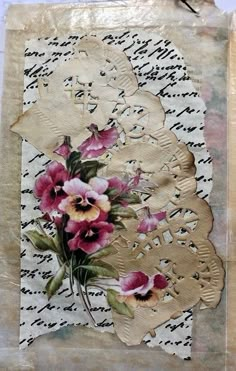 altered paper with flowers and lace on it