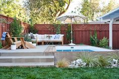 a backyard with a hot tub and patio furniture