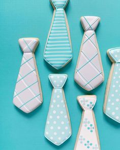 decorated cookies in the shape of ties on a blue background