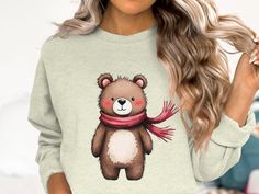 a woman wearing a sweater with a bear on it