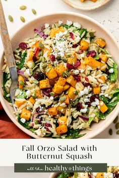 a salad with butternut squash and cranberries in a bowl