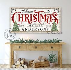 a christmas sign on a wall above a table