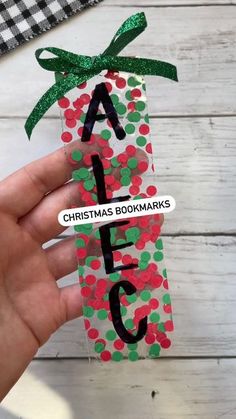 someone is holding up a christmas bookmark