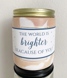 there is a candle with a label on it that says, the world is brighter because of you