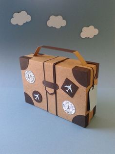 a cardboard box with an airplane design on the front and side, sitting on top of a blue surface