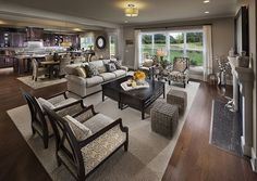 a living room filled with furniture and lots of windows