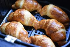 several croissants are being cooked in an air fryer