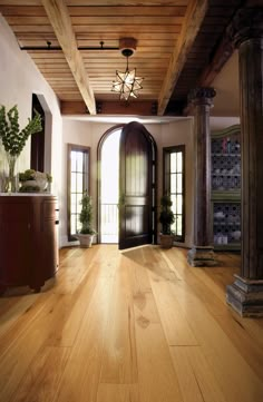 an empty room with wooden floors and doors