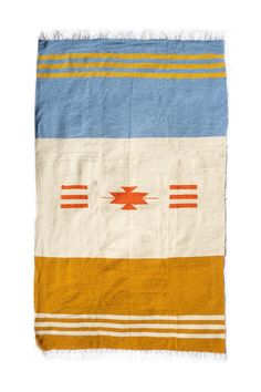 a blanket with an orange, yellow and blue design on it's side is shown