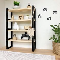 a shelf with various items on it next to a potted plant