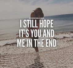 a woman standing on top of a sandy beach with the words still hope it's you and me in the end