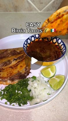 a plate with meat, rice and vegetables on it next to a bowl of sauce