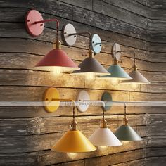 several different colored lights are hanging on the wall next to a wood paneled wall