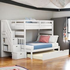 a white bunk bed sitting next to a window in a room with wooden floors and walls