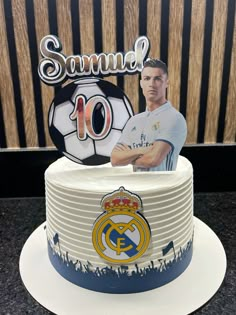 there is a cake with a photo of the player on it and a soccer ball in the background