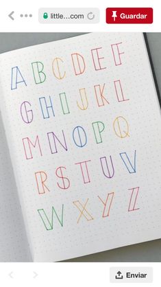 an open notebook with colorful letters on it