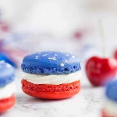 red, white and blue macarons are on display with the words cherry cheesecake macaroons