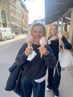 two girls eating ice cream on the street