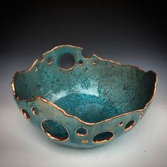 a blue bowl with holes in it on a table