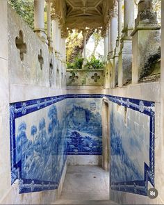 the inside of an old building with blue and white tiles