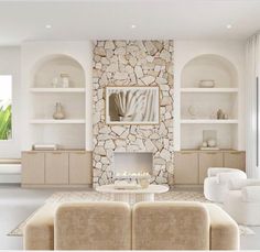 a living room filled with furniture and a fire place in front of a stone wall