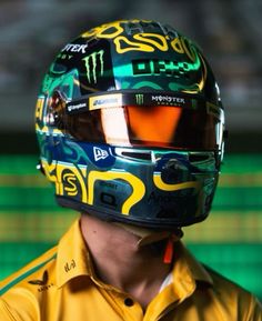 a man wearing a yellow shirt and helmet with the word monster written on it's side