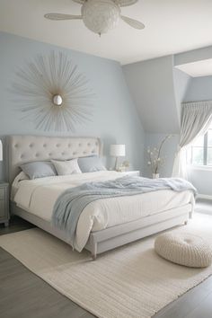 a bedroom with blue walls and white furniture