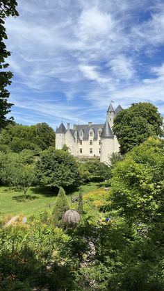 an old castle surrounded by lush green trees