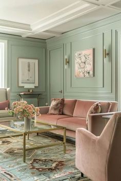 a living room filled with lots of furniture and walls painted in pastel green paint