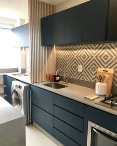 a kitchen with a washer and dryer in it