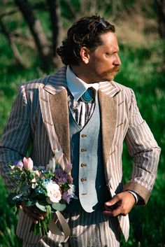 "ABOUT THIS STYLE: Sometimes we just want to break the rules. To create something bold, masculine, dandish. This suit is more than a little bit Western, but Western via the late 1960s and early 1970s. It is more than a bit Edwardian, but \"Edwardian\" via the 1970s Savile Row looks of Tommy Nutter. The jacket and pant are made from utterly breathable and lightweight cotton seersucker, with a linen vest, and a linen tuxedo stripe, and a linen wrap around Victorian style lapel facing. A high colla Mismatched Suit, Tommy Nutter Suits, Old Western Aesthetic Outfits Men, Interesting Suits Men, Garden Tea Party Outfit Men, Vintage Tea Party Outfit Men, Cowboy Suits For Men, Interesting Suits, Vintage Single-breasted Three-piece Suit