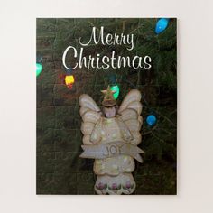 a merry christmas card with an angel holding a lit candle in its hands and the words merry christmas on it