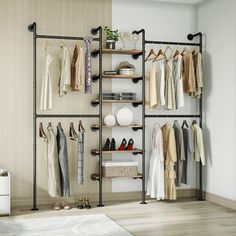 an open closet with clothes and shoes hanging on the wall, next to a bed