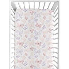 a white crib with pink and purple butterflies on it