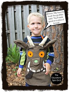 a young boy wearing a costume made to look like an animal with horns and big eyes