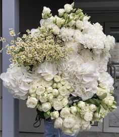 a person holding a bunch of white flowers