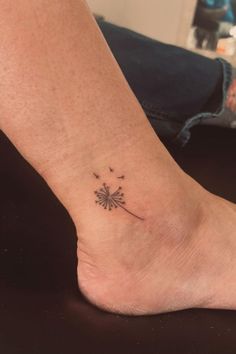 a small dandelion tattoo on the ankle