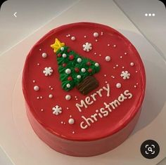 a red cake decorated with a christmas tree