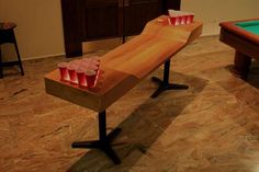 a pool table with red cups on it