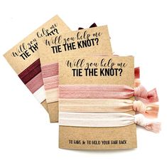 three brown paper tags with pink and white ribbons on them, one says will you be the knot? while the other says will you be the knot?