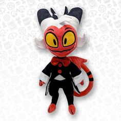 a red and black stuffed animal with yellow eyes sitting on top of a white background