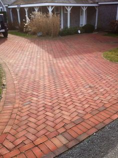 a red brick driveway in front of a house