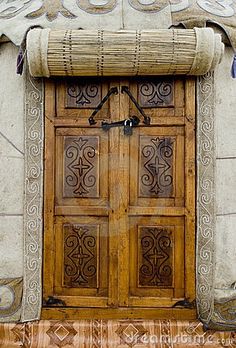 an old wooden door with decorative designs on it