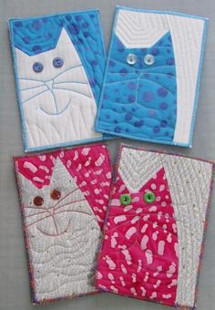 four quilted coasters with cats on them, one is pink and the other is blue