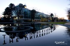 the building is reflecting in the water outside