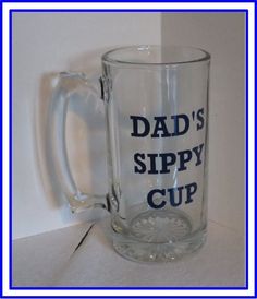 a glass mug with the words grandpa's sippy cup on it is shown