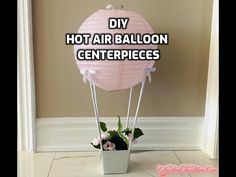 a hot air balloon centerpiece with flowers in it and the words diy, hot air balloon centerpieces