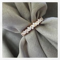 an image of a ring on top of a fabric material with diamonds in it's center