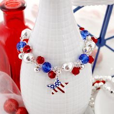 Silver tone toggle clasp bracelet featuring red and blue crystal beads with silver round beads and a patriotic 1” star charm with an enamel USA flag pattern. Perfect for the 4th of July! Patriotic American Flag Jewelry For Independence Day, Silver Jewelry For 4th Of July Gift, Silver Jewelry Gift For 4th Of July, Patriotic Nickel-free Jewelry For 4th Of July, Red American Flag Jewelry For Independence Day, Patriotic American Flag Jewelry For 4th Of July, Red Patriotic Jewelry For Independence Day, Patriotic Beaded Bracelets For 4th Of July, Patriotic Silver Jewelry For Independence Day