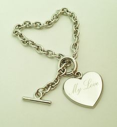 a heart shaped keychain with the word my love on it's side